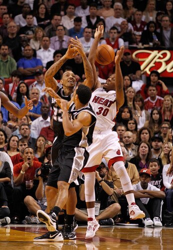 MIAMI, FL - JANUARY 17: Norris Cole #30 of the Miami Heat fights for a loose ball with Daniel Green #4 and Malcolm Thomas #23 of the San Antonio Spurs during a game  at American Airlines Arena on January 17, 2012 in Miami, Florida. <br /><br /><span class="help">(Photo by Mike Ehrmann/Getty Images)</span>