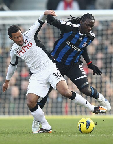 LONDON, ENGLAND - FEBRUARY 11:  Mousa Demele of Fulham tries to tackle Kenwyne Jones of Stoke City during the Barclays Premier League match between Fulham and Stoke City at Craven Cottage on February 11, 2012 in London, England.  <br /><br /><span class="help">(Photo by Ian Walton/Getty Images)</span>