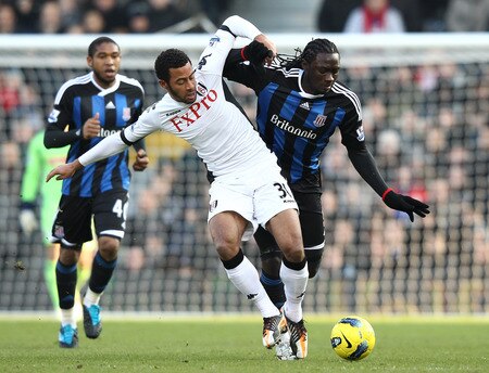 LONDON, ENGLAND - FEBRUARY 11:  Mousa Demele of Fulham tries to tackle Kenwyne Jones of Stoke City during the Barclays Premier League match between Fulham and Stoke City at Craven Cottage on February 11, 2012 in London, England.  <br /><br /><span class="help">(Photo by Ian Walton/Getty Images)</span>