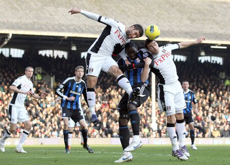 LONDON, ENGLAND - FEBRUARY 11:  Kenwyne Jones of Stoke City is tackled by Aaron Hughes and Stephen Kelly of Fulham during the Barclays Premier League match between Fulham and Stoke City at Craven Cottage on February 11, 2012 in London, England.  <br /><br /><span class="help">(Photo by Ian Walton/Getty Images)</span>