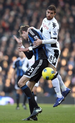 LONDON, ENGLAND - FEBRUARY 11:  Peter Crouch of Stoke City is tackled by Aaron Hughes of Fulham during the Barclays Premier League match between Fulham and Stoke City at Craven Cottage on February 11, 2012 in London, England.  <br /><br /><span class="help">(Photo by Ian Walton/Getty Images)</span>
