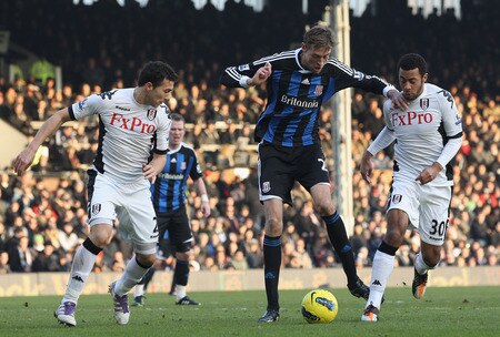 LONDON, ENGLAND - FEBRUARY 11:  Stephen Kelly of Fulham tries to tackle Peter Crouch of Stoke City during the Barclays Premier League match between Fulham and Stoke City at Craven Cottage on February 11, 2012 in London, England.  <br /><br /><span class="help">(Photo by Ian Walton/Getty Images)</span>