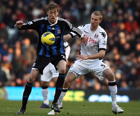 LONDON, ENGLAND - FEBRUARY 11:  Brede Hangeland of Fulham tries to tackle Peter Crouch of Stoke City during the Barclays Premier League match between Fulham and Stoke City at Craven Cottage on February 11, 2012 in London, England.  <br /><br /><span class="help">(Photo by Ian Walton/Getty Images)</span>