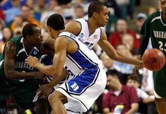 GREENSBORO, NC - MARCH 19:  Lance Thomas #42 of the Duke Blue Devils grabs a loose ball against Malik Alvin #3 of the Binghamton Bearcats and Gerald Henderson #15 during the first round of the NCAA Division I Men's Basketball Tournament at the Greensboro Coliseum on March 19, 2009 in Greensboro, North Carolina.  (Photo by Streeter Lecka/Getty Images)