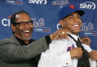 LONG ISLAND CITY, NY - DECEMBER 17:  New York Mets Manager Jerry Manuel helps Francisco Rodriquez put on a Mets jersey for the first time during a press conference to introduce him on December 17, 2008 at the Citigroup Building in New York City.  (Photo by Mike Stobe/Getty Images)