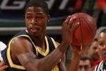 INDIANAPOLIS - MARCH 13:  DeShawn Sims #34 of the Michigan Wolverines looks to pass the ball out of the post against Dominique Keller #23 of the Illinois Fighting Illini during the second round of the Big Ten Men's Basketball Tournament at Conseco Fieldhouse on March 13, 2009 in Indianapolis, Indiana.  (Photo by Jonathan Daniel/Getty Images)