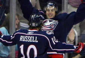 COLUMBUS, OH - MARCH 18: Kris Russell #10 of the Columbus Blue Jackets greets teammate Antoine Vermette #50 who scored in overtime to defeat the Chicago Blackhawks 4-3 at the Nationwide Arena March 18, 2009 in Columbus, Ohio. (Photo by Bruce Bennett/Getty Images)