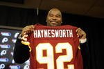ASHBURN, VA - FEBRUARY 27:  Albert Haynesworth posese with his new jersey at a press conference after signing a 7-year contract worth approximately $100 million with the Washington Redskins on February 27, 2009 at Redskins Park in Ashburn, Virginia.  (Photo by Mitchell Layton/Getty Images)
