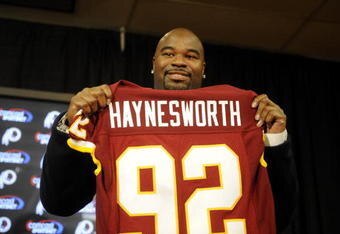 ASHBURN, VA - FEBRUARY 27:  Albert Haynesworth posese with his new jersey at a press conference after signing a 7-year contract worth approximately $100 million with the Washington Redskins on February 27, 2009 at Redskins Park in Ashburn, Virginia.  (Photo by Mitchell Layton/Getty Images)