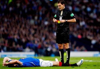 GLASGOW, UNITED KINGDOM - MARCH 15:  Rangers player Kirk Broadfoot lays down before being sent off by referee Douglas Mcdonald after fouling Celtic player Aiden Mcgeady in the penalty box for a penalty during the CIS Insurance Cup Final between Rangers and Celtic at Hampden Park on March 15, 2009 in Glasgow, Scotland.  (Photo by Stu Forster/Getty Images)