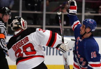 NEW YORK - APRIL 13: Sean Avery #16 of the New York Rangers tries to screen Martin Brodeur #30 of the New Jersey Devils during game three of the 2008 NHL Eastern Conference Quarterfinals on April 13, 2008 at Madison Square Garden in New York City.  (Photo by Jim McIsaac/Getty Images)