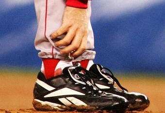 NEW YORK - OCTOBER 19:   Pitcher Curt Schilling #38 of the Boston Red Sox grabs at his ankle as it appears to be bleeding in the fourth inning during game six of the American League Championship Series against the New York Yankees on October 19, 2004 at Yankee Stadium in the Bronx borough of New York City. (Photo by Al Bello/Getty Images)