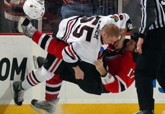 NEWARK, NJ - MARCH 17:  Ben Eager #55 of the Chicago Blackhawks takes down Mike Rupp #17 of the New Jersey Devils during their fight at the Prudential Center on March 17, 2009 in Newark, New Jersey.  (Photo by Jim McIsaac/Getty Images)