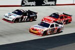 BRISTOL, TN - MARCH 22:  Sam Hornish Jr., driver of the #77 Mobil 1 Dodge, races Kyle Busch, driver of the #18 Snickers Toyota, and Tony Stewart, driver of the #14 Office Depot Chevrolet, during the NASCAR Sprint Cup Series Food City 500 at Bristol Motor Speedway on March 22, 2009 in Bristol, Tennessee.  (Photo by Geoff Burke/Getty Images for NASCAR)