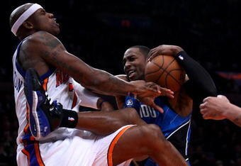 NEW YORK - FEBRUARY 25:  Dwight Howard #12 of the Orlando Magic is fouled by Al Harrington #7 of the New York Knicks at Madison Square Garden February 25, 2009 in New York City. NOTE TO USER: User expressly acknowledges and agrees that, by downloading and/or using this Photograph, User is consenting to the terms and conditions of the Getty Images License Agreement.  (Photo by Chris McGrath/Getty Images)