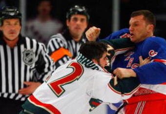 NEW YORK - MARCH 24:  Cal Clutterbuck #22 of the Minnesota Wild fights Sean Avery #16 of the New York Rangers during the first period at Madison Square Garden March 24, 2009 in New York City.  (Photo by Jim McIsaac/Getty Images)