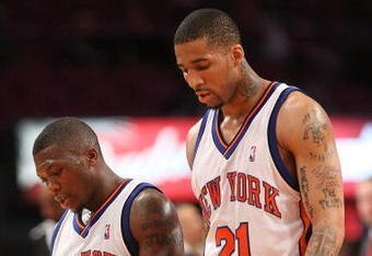 NEW YORK - MARCH 20:  Nate Robinson #4 of the New York Knicks walks from the court with teammate Wilson Chandler #21 against the Sacramento Kingson March 20, 2009 at Madison Square Garden in New York City. NOTE TO USER: User expressly acknowledges and agrees that, by downloading and or using this photograph, User is consenting to the terms and conditions of the Getty Images License Agreement.  (Photo by Nick Laham/Getty Images)