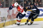 BUFFALO, NY - FEBRUARY 10: Richard Zednik #20 of the Florida Panthers is checked from behind by Derek Roy #9 of  the Buffalo Sabres on February 10, 2008 at HSBC Arena in Buffalo, New York.  (Photo by Rick Stewart/Getty Images)  