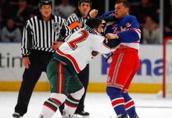 NEW YORK - MARCH 24:  Cal Clutterbuck #22 of the Minnesota Wild fights Sean Avery #16 of the New York Rangers during the first period at Madison Square Garden March 24, 2009 in New York City.  (Photo by Jim McIsaac/Getty Images)