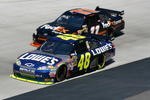 BRISTOL, TN - MARCH 22:  Denny Hamlin, driver of the #11 FedEx Express Toyota, races Jimmie Johnson, driver of the #48 Lowe's Chevrolet, side by side during the NASCAR Sprint Cup Series Food City 500 at Bristol Motor Speedway on March 22, 2009 in Bristol, Tennessee.  (Photo by Geoff Burke/Getty Images for NASCAR)