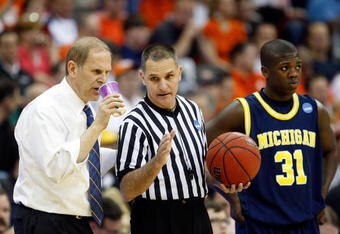KANSAS CITY, MO - MARCH 19:  NCAA Referee Kelly Self speaks to Head Coach John Beilein of the Michigan Wolverines during the first round of the NCAA Division I Men's Basketball Tournament between the Michigan Wolverines and the Clemson Tigers at the Sprint Center on March 19, 2009 in Kansas City, Missouri. The Wolverines defeated the Tigers 62-59. (Photo by Jamie Squire/Getty Images)