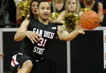 LAS VEGAS - MARCH 14:  Lorrenzo Wade #31 of the San Diego State Aztecs tries to stop the ball from going out-of-bounds during the championship game against the Utah Utes in the Conoco Mountain West Conference tournament at the Thomas & Mack Center March 14, 2009 in Las Vegas, Nevada. The Utes won the title 52-20.  (Photo by Ethan Miller/Getty Images)