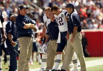 FOXBORO, MA - SEPTEMBER 7:  Quarterback Tom Brady #12 of the New England Patriots walks off the field with the aid of the Patriots staff after being injured on a play during their NFL game against the Kansas City Chiefs on September 7, 2008 at Gillette Stadium in Foxboro, Massachusetts. The Patriots defeated the Chiefs 17-10. (Photo by Elsa Garrison/Getty Images)