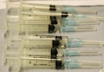 BOLTON, UNITED KINGDOM - MARCH 29:  Syringes are lined up as teams of workers from Bolton Primary Care Trust carry out a mass vaccination exercise on March 29, 2006, Bolton, England. Health officials immunised 1,000 volunteers  in the Bolton Arena as part of the exercise to test the time and logistics of mass immunisation in the event of a flu pandemic. The last flu pandemic was 38 years ago and it's recurrence is every 30-40 years. Volunteers were not actually injected instead an orange was used to simulate the vaccination.  (Photo by Christopher Furlong/Getty Images)
