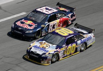 DAYTONA BEACH, FL - FEBRUARY 11:  David Reutimann driver of the #00 Aaron's Dream Machine Toyota races with Brian Vickers driver of the #83 Red Bull Toyota during practice for the NASCAR Sprint Cup Series Daytona 500 at Daytona International Speedway on February 11, 2009 in Daytona Beach, Florida.  (Photo by John Harrelson/Getty Images for NASCAR)