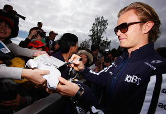 MELBOURNE, AUSTRALIA - MARCH 27:  Nico Rosberg of Germany and Williams signs autographs for race fans prior to practice for the Australian Formula One Grand Prix at the Albert Park Circuit on March 27, 2009 in Melbourne, Australia.  (Photo by Mark Thompson/Getty Images)