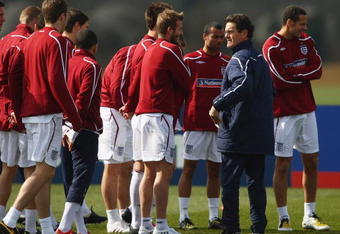 ST ALBANS, ENGLAND - MARCH 24:  England manager Fabio Capello talks with David Beckham during England training at London Colney on March 24, 2009 in St Albans, England.  (Photo by Jamie McDonald/Getty Images)
