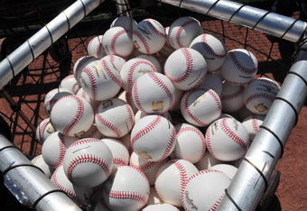 CLEARWATER, FL - MARCH 2:  New baseballs with gold logos fill a batting practice basket as the USA World Baseball Classic team  practices March 2, 2009 at Bright House Field in Clearwater, Florida.  (Photo by Al Messerschmidt/Getty Images)