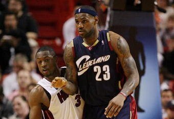 MIAMI - DECEMBER 30:  LeBron James #23 of the Cleveland Cavaliers is guarded closely by Dwyane Wade #3 of the Miami Heat at American Airlines Arena on December 30, 2008 in Miami, Florida. The Heat defeated the Cavaliers 104-95. NOTE TO USER: User expressly acknowledges and agrees that, by downloading and/or using this Photograph, user is consenting to the terms and conditions of the Getty Images License Agreement.  (Photo by Doug Benc/Getty Images)