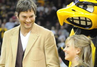 IOWA CITY, IA - DECEMBER 12: Olympic medalist Shawn Johnson (R) and actor Ashton Kutcher are honored during halftime of the Iowa-Iowa State college basketball game on December 12, 2008 at the University of Iowa in Iowa City, Iowa. Johnson and Kutcher, both from Iowa, were in Iowa City raising money for flood relief charities in Eastern Iowa after a 500 year flood devastated the area. (Photo by David Greedy/Getty Images)
