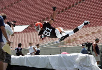 LOS ANGELES - MAY 20:  Wide receiver Travis Wilson #81, the Cleveland Browns third round NFL draft pick, dives with a ball during a trading card shoot at the NFL Players Rookie Premiere Photoshoot on May 20, 2006 at the Los Angeles Memorial Coliseum in Los Angeles, California. (Photo by Paul Spinelli/Getty Images)
