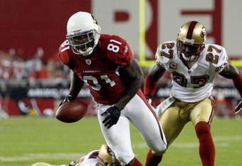 GLENDALE, AZ - NOVEMBER 10:  Anquan Boldin #81 of the Arizona Cardinals gets a way from Walt Harris #27 and Mark Roman #26 of the San Francisco 49ers after a catch to  score a touchdown during the second quarter at University of Phoenix Stadium on November, 10 2008 in Glendale, Arizona.  (Photo by Harry How/Getty Images)