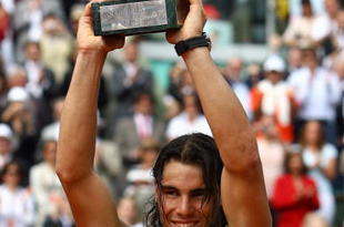 PARIS - JUNE 08:  Rafael Nadal of Spain lifts the trophy after defeating Roger Federer of Switzerland after the Men's Singles Final match on day fifteen of the French Open at Roland Garros on June 8, 2008 in Paris, France.  (Photo by Julian Finney/Getty Images)