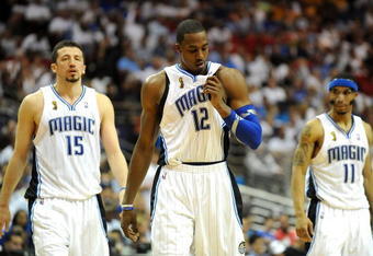 ORLANDO, FL - JUNE 14:  (L-R) Hedo Turkoglu #15, Dwight Howard #12 and Courtney Lee #11 of the Orlando Magic walk across the court in the final moments of the Magic loss to the Los Angeles Lakers in Game Five of the 2009 NBA Finals on June 14, 2009 at Amway Arena in Orlando, Florida.  NOTE TO USER:  User expressly acknowledges and agrees that, by downloading and or using this photograph, User is consenting to the terms and conditions of the Getty Images License Agreement.  (Photo by Ronald Martinez/Getty Images)