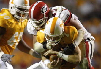 KNOXVILLE, TN - OCTOBER 11:  Quarterback Casey Clausen #7 of the Tennessee Volunteers is sacked by David Pollack #47 of the Georgia Bulldogs in the second half on October 11, 2003 at Neyland Stadium in Knoxville, Tennessee. Georgia defeated Tennessee 41-14.  (Photo by Elsa/Getty Images)