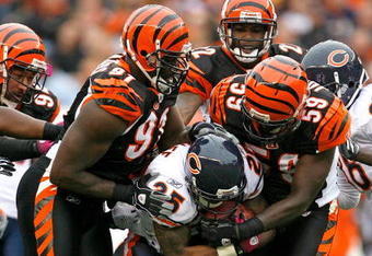 CINCINNATI - OCTOBER 25:  Garrett Wolfe #25 of the Chicago Bears is tackled by Robert Geathers #91 and Brandon Johnson #59 of the Cincinnati Bengals during the NFL game at Paul Brown Stadium on October 25, 2009 in Cincinnati, Ohio. The Bengals won 45-10.  (Photo by Andy Lyons/Getty Images)