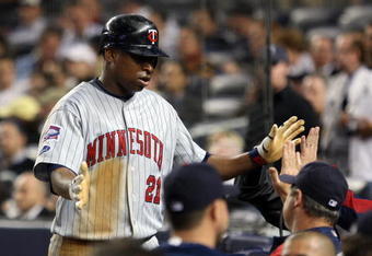 NEW YORK - OCTOBER 09:  Delmon Young #21 of the Minnesota Twins celebrates after being driven home on a triple by Brendan Harris #23 in the sixth inning against the New York Yankees in Game Two of the ALDS during the 2009 MLB Playoffs at Yankee Stadium on October 9, 2009 in the Bronx borough of New York City.  (Photo by Jim McIsaac/Getty Images)