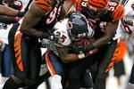 CINCINNATI - OCTOBER 25:  Garrett Wolfe #25 of the Chicago Bears is tackled by Robert Geathers #91 and Brandon Johnson #59 of the Cincinnati Bengals during the NFL game at Paul Brown Stadium on October 25, 2009 in Cincinnati, Ohio. The Bengals won 45-10.  (Photo by Andy Lyons/Getty Images)