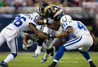 ST. LOUIS, MO - OCTOBER 25: Randy McMichael #84 of the St. Louis Rams is tackled by Kelvin Hayden #26 and Antoine Bethea #41 of the Indianapolis Colts at the Edward Jones Dome on October 25, 2009 in St. Louis, Missouri.  (Photo by Dilip Vishwanat/Getty Images)