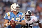 SAN DIEGO, CA - OCTOBER 19:  Quarterback Philip Rivers #17 of  the San Diego Chargers runs against the tackle of Darrell Reid #95 of the Denver Broncos during Monday Night Football on October 19, 2009 at Qualcomm Stadium in San Diego, California. (Photo by Donald Miralle/Getty Images)