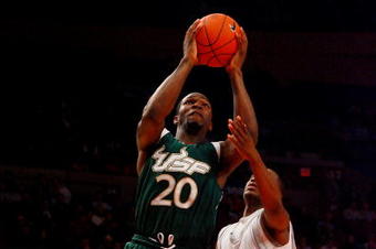 NEW YORK - MARCH 10:  Dominique Jones #20 of the USF Bulls goes to the hoop against Eugene Harvey #20 of the Seton Hall Pirates during the first round of the Big East Tournament at Madison Square Garden on March 10, 2009 in New York City.  (Photo by Jim McIsaac/Getty Images)