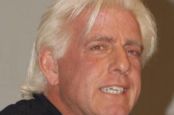 GARDEN CITY, NY - MARCH 3:  World Wrestling Entertainment (WWE) professional wrestler Ric Flair speaks on a panel during the 'Professor For A Day' event at Nassau Community College March 3, 2003 in Garden City, New York. Flair acted as an assistant professor to WWE CEO Linda McMahon, who lectured a group of sports marketing majors on the marketing and promotional strategies that have made the WWE a long-term success.  (Photo By Steven Henry/Getty Images)