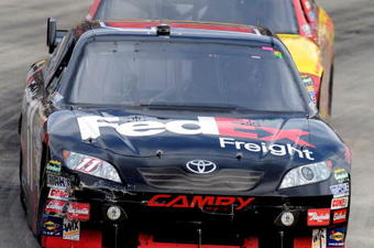 MARTINSVILLE, VA - OCTOBER 25:  Denny Hamlin, driver of the #11 FedEx Freight Toyota, leads Kevin Harvick, driver of the #29 Shell/Pennzoil Chevrolet, during the NASCAR Sprint Cup Series TUMS Fast Relief 500 at Martinsville Speedway on October 25, 2009 in Martinsville, Virginia.  (Photo by John Harrelson/Getty Images)