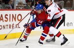 kMONTREAL- OCTOBER 17:  Tomas Plekanec #14 of the Montreal Canadiens battles for the puck in the corner with Chris Campoli #14 of the Ottawa Senators during the NHL game on October 17, 2009 at the Bell Centre in Montreal, Quebec, Canada.  (Photo by Richard Wolowicz/Getty Images)