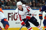 UNIONDALE, NY - OCTOBER 24:  Mike Green #52 of the Washington Capitals skates against Matt Moulson #26 of the New York Islanders on October 24, 2009 at Nassau Coliseum in Uniondale, New York. The Capitals won the game 3-2 in overtime.  (Photo by Jim McIsaac/Getty Images)
