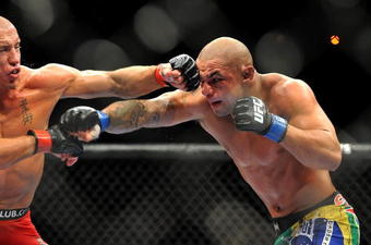 LAS VEGAS - JULY 11:  (L-R) Georges St. Pierre battles Thiago Alves during their welterweight title bout during UFC 100 on July 11, 2009 in Las Vegas, Nevada.  (Photo by Jon Kopaloff/Getty Images)